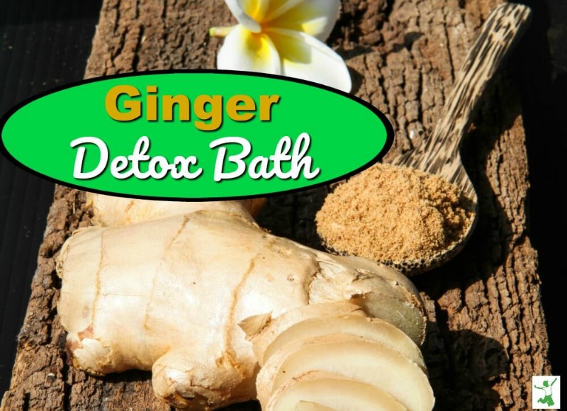 fresh ginger root and powder with a flower on a table