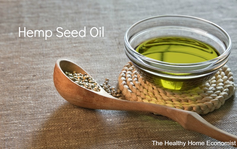 bowl of unrefined hemp seeds and oil on a table