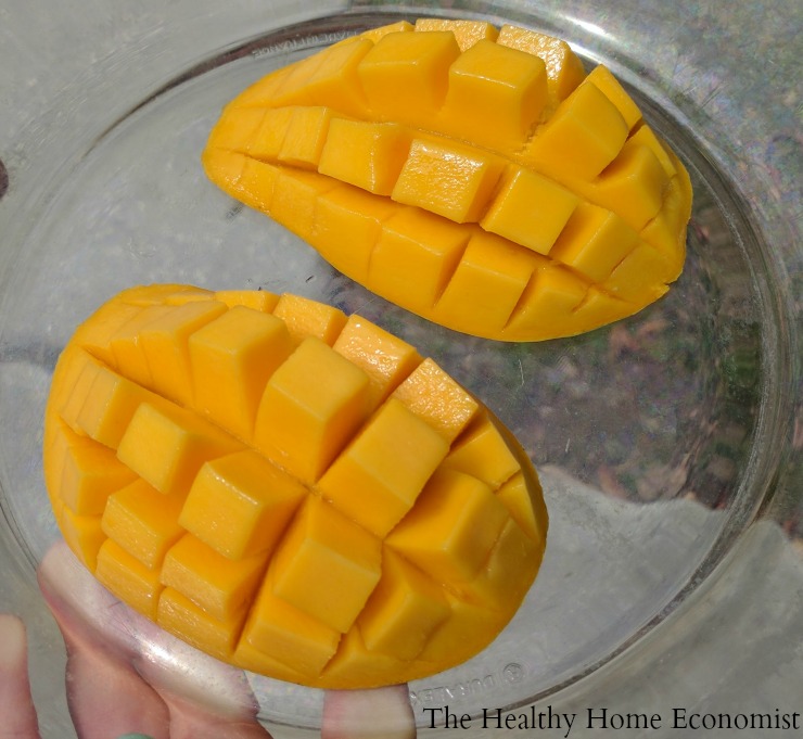 tow halves of sliced mango on a glass plate