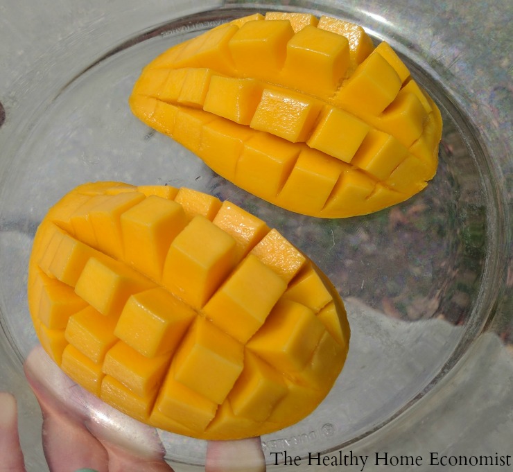 tow halves of sliced mango on a glass plate