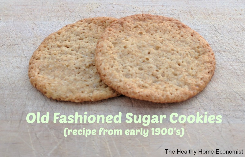 two old fashioned sugar cookies on a cutting board