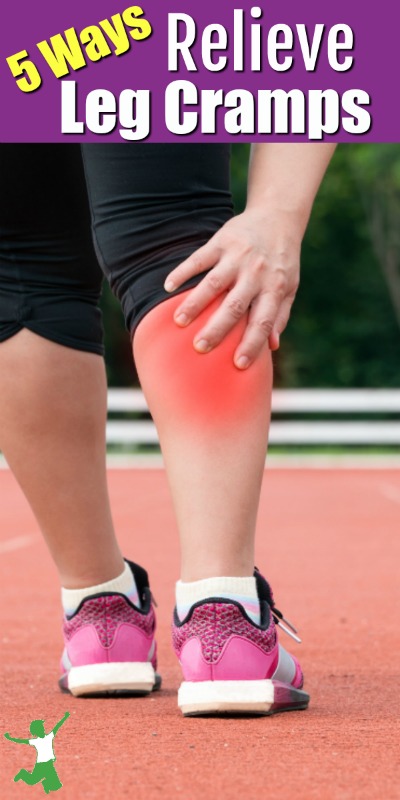 woman grabbing her cramping leg in pain