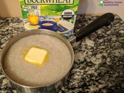 cooked buckwheat porridge in a pan with a pat of butter