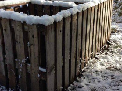 homemade compost bin rimmed with newly fallen snow