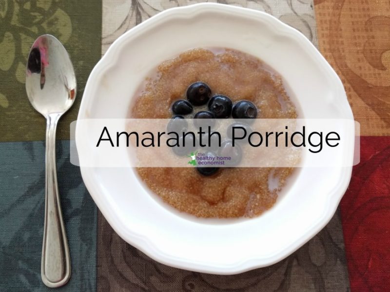 amaranth porridge in a white bowl with blueberries