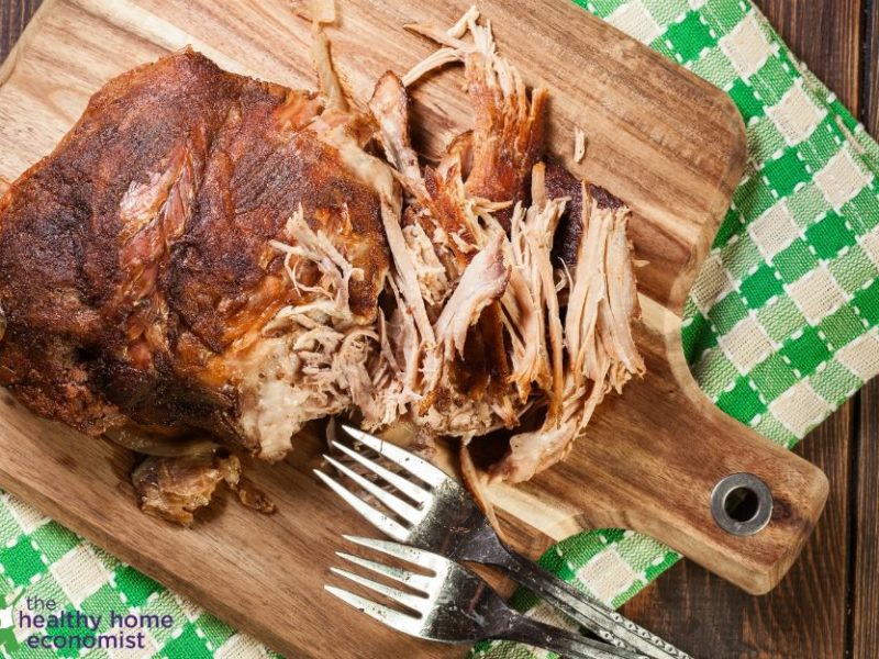 pulled pork shoulder on wooden cutting board