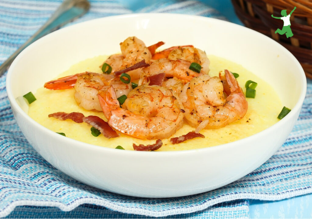 grain free shrimp and grits in white bowl on blue tablecloth