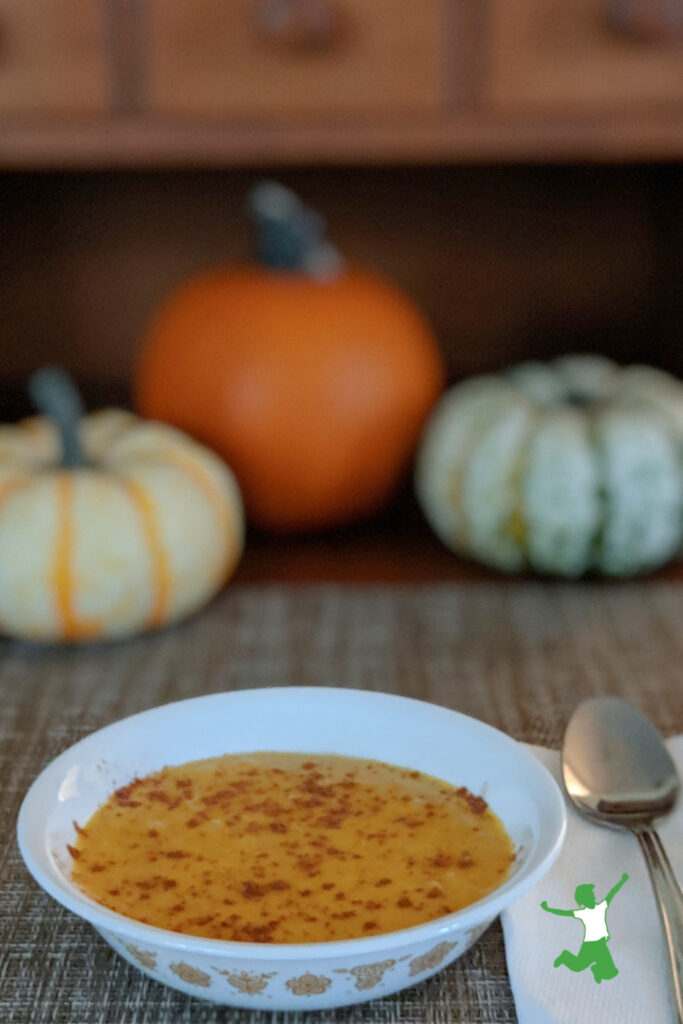 pumpkin spice porridge in a bowl with spoon