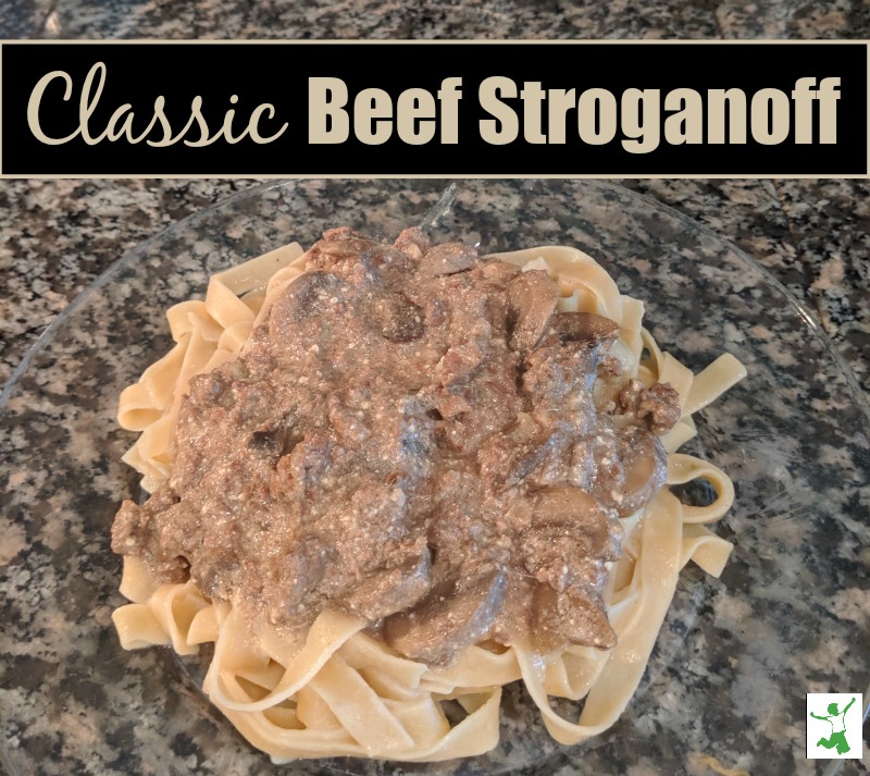 beef stroganoff over noodles on a plate