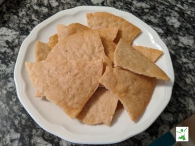 baked sourdough tortilla chips in a white bowl