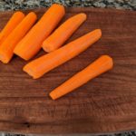 peeled carrots on a cutting board