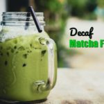 decaf matcha frappe in a mason jar mug with a straw on a wooden table