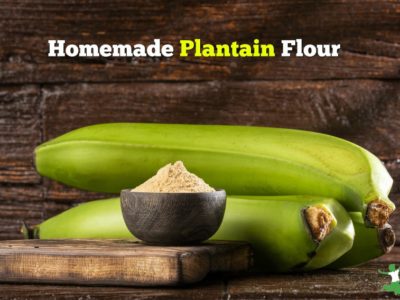 two unripe plantains and flour on a cutting board