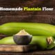 two unripe plantains and flour on a cutting board