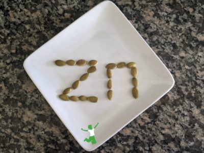 pumpkin seeds arranged in the word zinc on a plate
