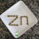 pumpkin seeds arranged in the word zinc on a plate