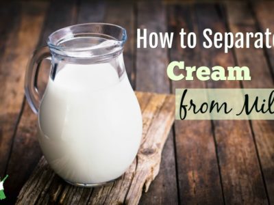 glass jar of separated cream on a wooden table