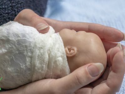 preterm baby in mother's hands