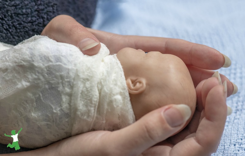 preterm baby in mother's hands