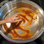 mexican spices in oil in a large pan