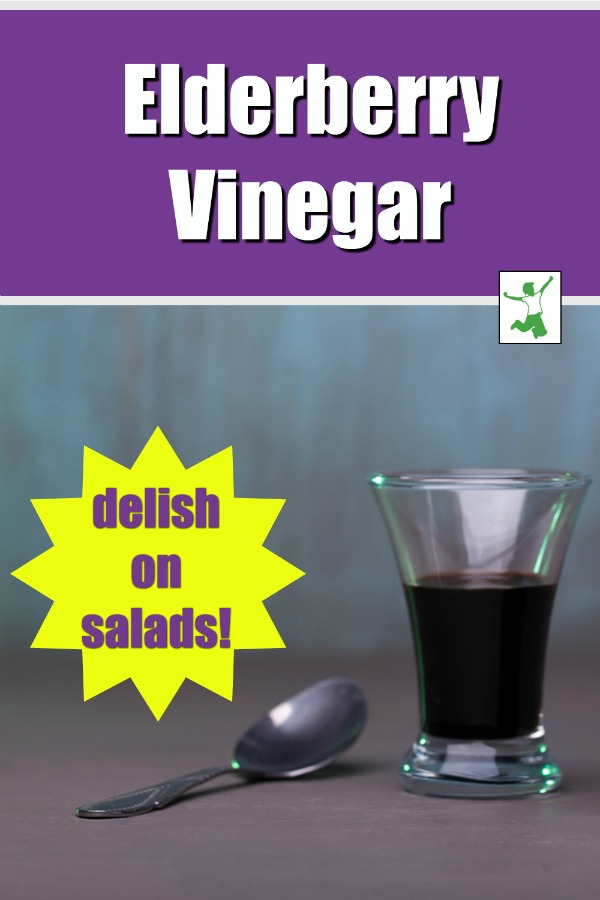 small glass of elderberry vinegar with a spoon