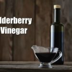 elderberry vinegar in a bottle on a wooden counter