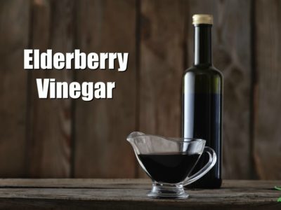 elderberry vinegar in a bottle on a wooden counter