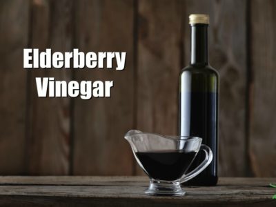 elderberry vinegar in a bottle on a wooden counter