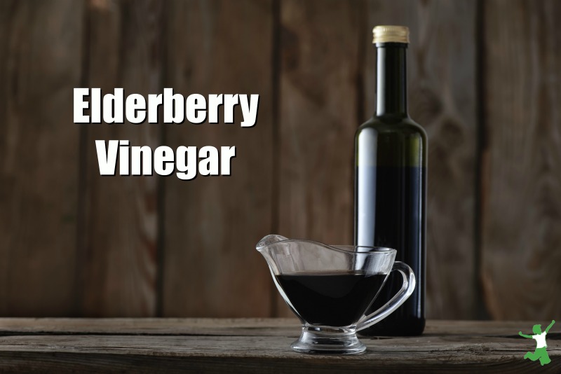 elderberry vinegar in a bottle on a wooden counter