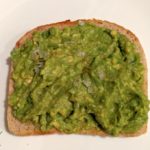 easy slice of avocado toast on a white plate