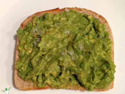 easy slice of avocado toast on a white plate