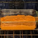 pumpkin batter in a bread pan in the oven