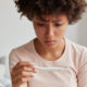 infertile woman staring at a pregnancy test result