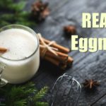 traditional eggnog in a glass with a cinnamon stick