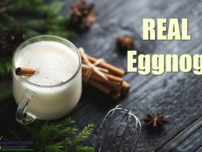 traditional eggnog in a glass with a cinnamon stick