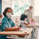 child wearing mask at school desk