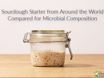 sourdough starter in a jar on a wooden counter