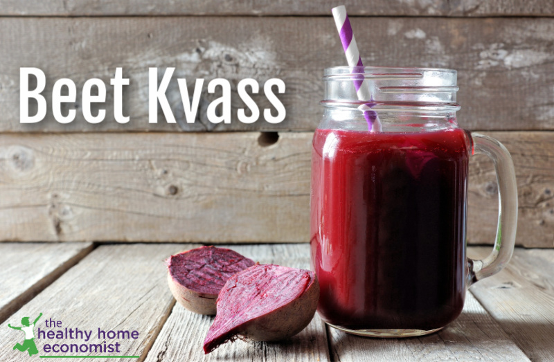 glass mug of homemade beet kvass with a paper straw