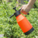 woman with safe pesticides in gallon sprayer