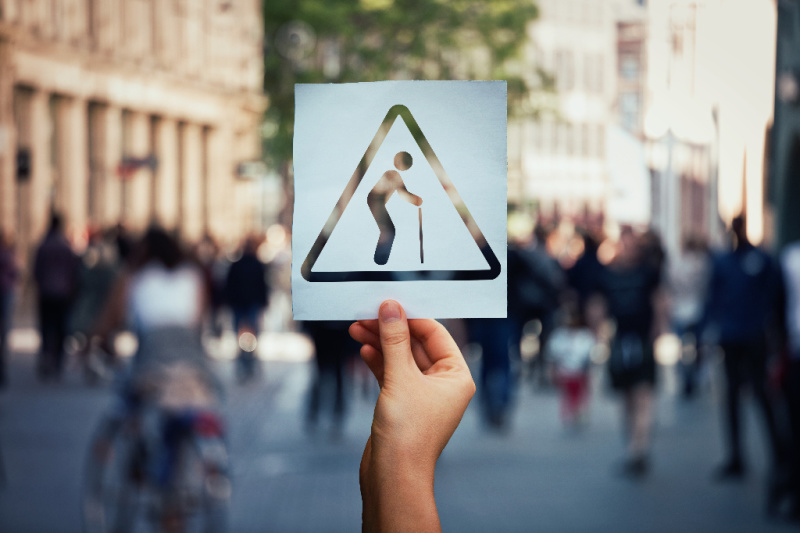 man with a cane in warning sign