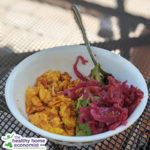 turmeric scrambled eggs with avocado in a bowl