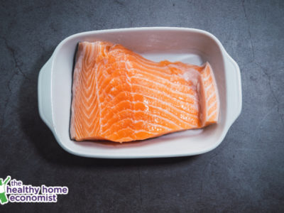 salmon fillet in a white baking dish