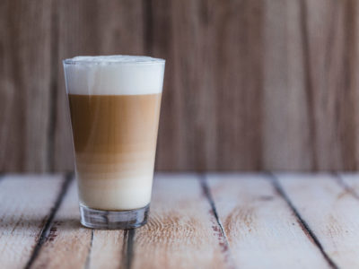 yerba mate latte with frothy milk in a glass