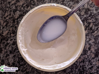 unstrained whey on a large spoon