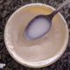 unstrained whey on a large spoon