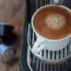 compostable coffee pods on a counter next to a single-use machine