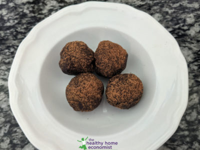 healthy energy bites dusted with cinnamon in a small white bowl