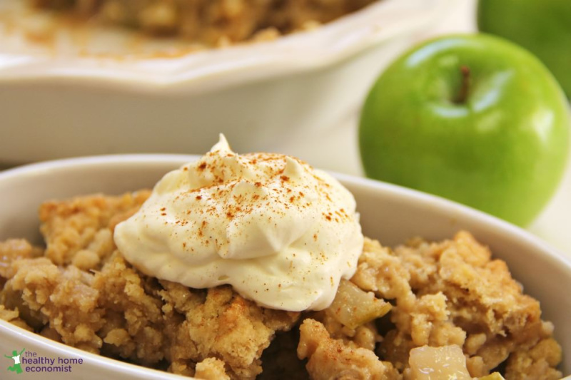 grain free apple cobbler with nondairy topping in a white dish