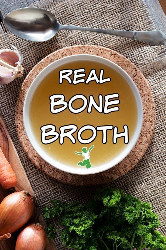 chicken bone broth in a cup on a table