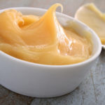 sugarfree, fruit sweetened lemon curd in a small white bowl with spoon
